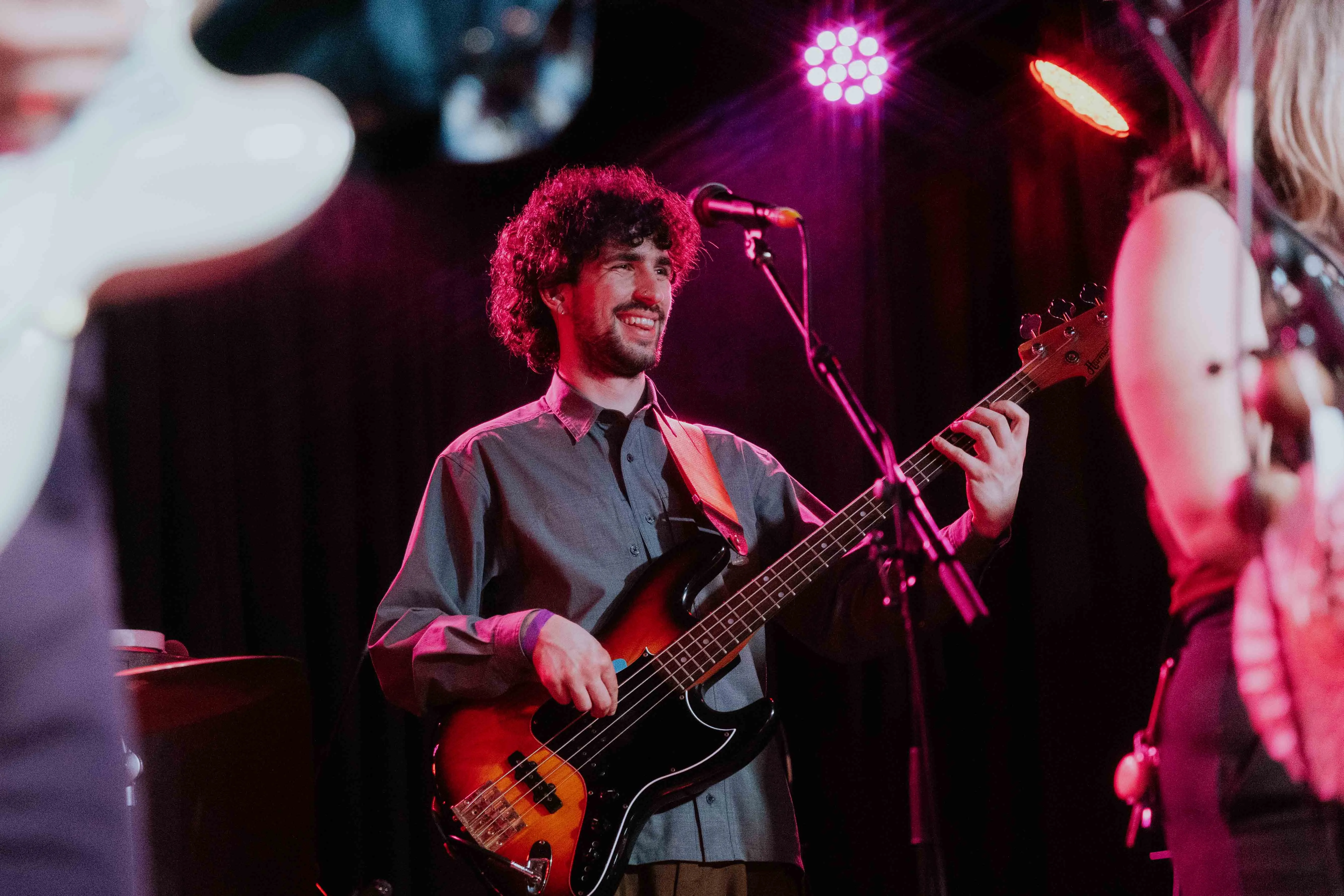 Candid shot of Michael Campelj performing bass